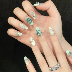 Mint green cat eye press-on nails with luxury blue crystals and silver glitter accents