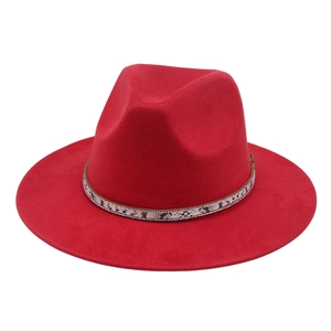 Close-up of red wool fedora with snake pattern band and sparkling rhinestones