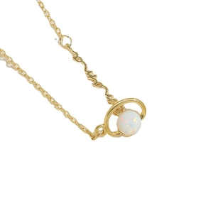 Elegant gold Saturn planet necklace with white opal stone on a minimalist thin chain