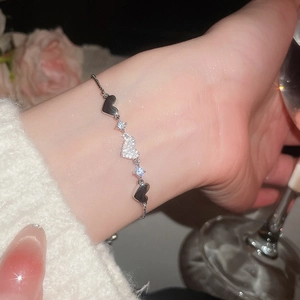 Close-up of elegant silver heart bracelet with cubic zirconia on woman's wrist