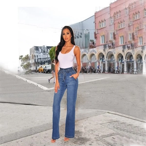 Detail shot of the lace-up high waist and denim texture on blue wide leg jeans