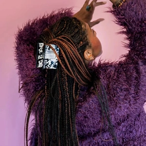 Detail view of composition book pattern marble hair claw clip on model's braided hair