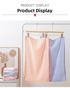 Hanging and stacked colorful plaid cotton tea towels in a clean home kitchen setting