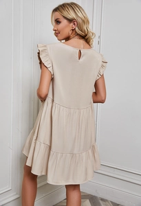 Detail of elegant beige ruffle sleeve summer dress with multi-layered tiered skirt back