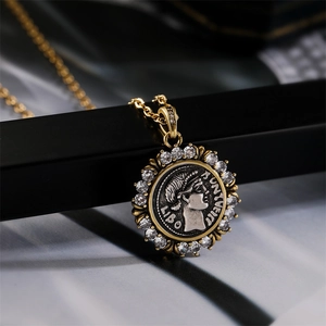 Macro detail of gold vintage Roman coin pendant necklace featuring clear zircon stones