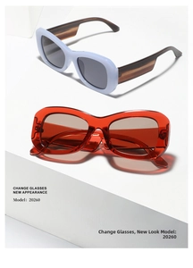 Detail view of square oversized sunglasses in light blue and transparent red frames