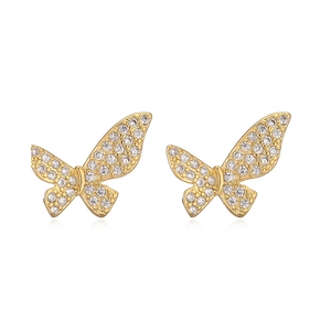 Macro detail of 18K gold plated bow earrings with sparkling clear zircon inlay