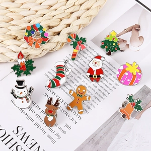 Set of 11 colorful Christmas enamel pins featuring Santa, reindeer and tree on a rustic mat