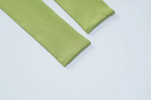 Close-up of the green knit fabric texture and slit edge detail on the summer set skirt