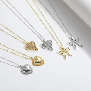 Minimalist vintage love heart and bow pendant necklaces in gold and silver plating