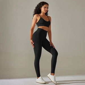 Detail of black seamless yoga set showing high waist leggings and thin strap sports bra
