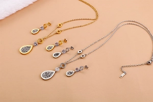 Detailed view of leaf-shaped jewelry sets with 'Forever Love' engraving and zircon inlays