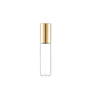 Clear glass essential oil roller bottle with elegant gold cap on white background