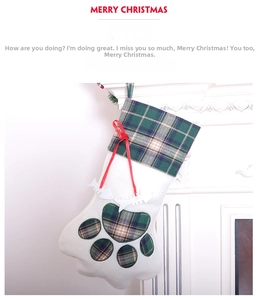 Detailed view of cat paw Christmas stocking with plaid patterns and fish bone charm