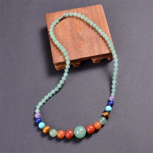 Close-up of bohemian colorful beads necklace with natural green and multi-color gemstones