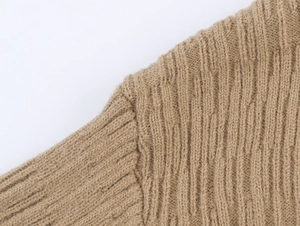Close-up detail of knitted fabric stitching on a brown two-piece cardigan set