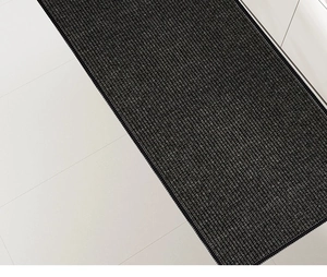 Detailed weave texture of anti-slip kitchen mat in dark grey with reinforced stitched edges