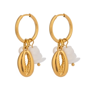 Gold hoop earrings with shell pendants and white natural stones in a bohemian vacation style