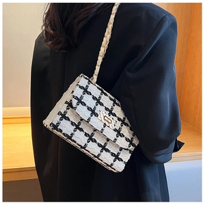 Detail of tweed plaid shoulder bag with golden square lock and metal chain strap