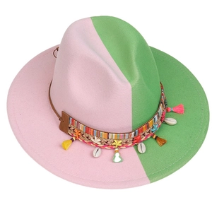 Close-up of pink and green fedora hat featuring sea shell and starfish ornaments