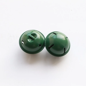 Detail of 4cm green lacquered metal bells with star cutouts for Christmas DIY