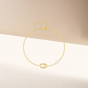 Macro detail of gold S925 sterling silver bracelet with oval zircon and adjustable chain