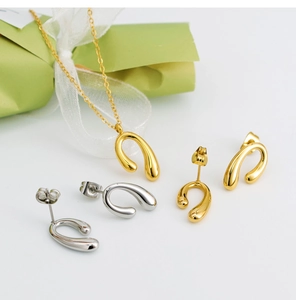 Minimalist gold necklace and U-shaped earrings set with elegant gift box packaging