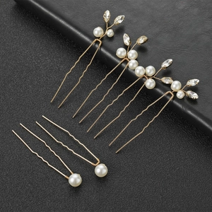 Set of bridal hair pins with gold metal, white pearls and sparkling leaf crystals