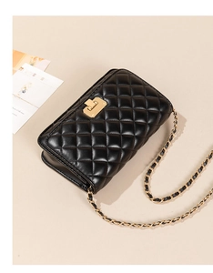 Top view of black quilted PU leather crossbody bag with golden chain strap and lock