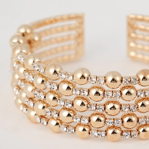 Luxurious gold-layered cuff bracelet with sparkling crystal rhinestones in a wide design