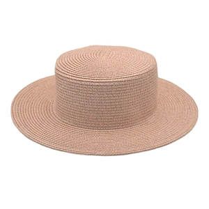 Close-up of a classic flat top straw boater hat featuring fine woven texture and khaki tone