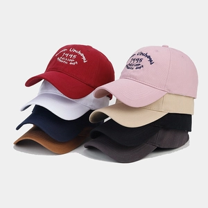Multiple colors of cotton baseball caps with vintage athletic embroidery detail