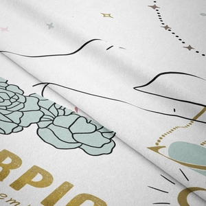 Macro shot of Scorpio zodiac tapestry fabric texture with floral patterns and gold lettering