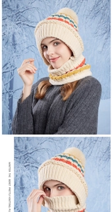Close-up of cream chunky knit winter hat and scarf set with colorful stripe details