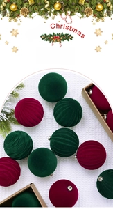 Macro detail of 8cm flocked Christmas baubles in burgundy and dark green with textures