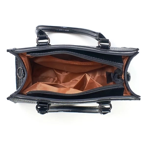 Detailed top view of black textured leather handbag with brown lining and interior pockets
