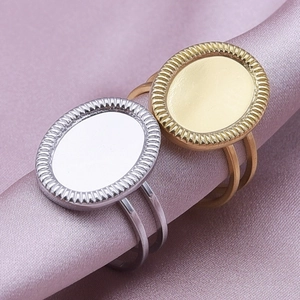 Detailed macro view of gold and silver oval DIY ring blanks on premium silk fabric