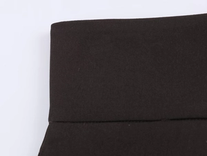 Close-up of black twill knit fabric with neat stitching on suit jacket waistband