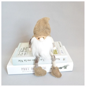 Close-up of a Nordic forest gnome plush with a tall felt hat and fluffy white beard decor