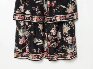 Detail of floral print linen blend dress with layered ruffles and striped hem trim