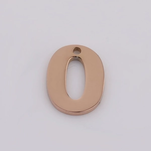 Macro detail of rose gold stainless steel number 0 pendant with smooth mirror finish