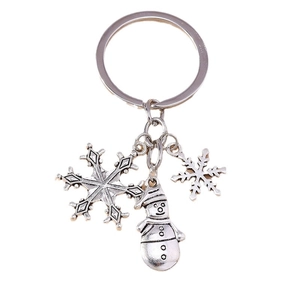 Silver metal Christmas snowman keychain with snowflake charms on white background