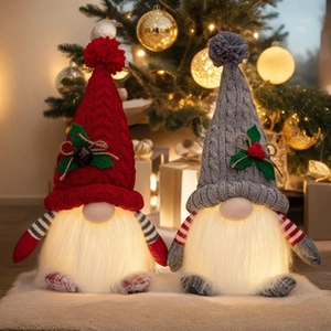 Close-up of glowing Christmas gnomes with knit hats in red and grey festive holiday decor