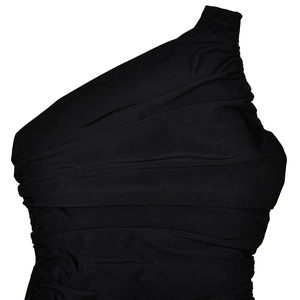 Detailed close-up of the black ruched fabric and one-shoulder seam on this dress
