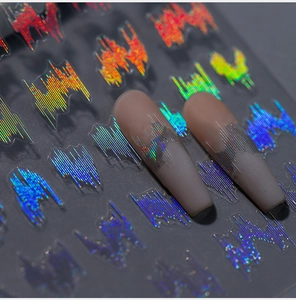 Macro detail of holographic wave nail stickers with laser fire effect on matte pink nails