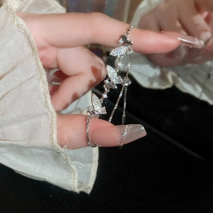 Close-up of a silver butterfly charm bracelet with sparkling zircon stones for women