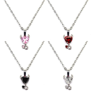 Detailed close-up of heart-shaped devil pendants with colorful cubic zirconia stones