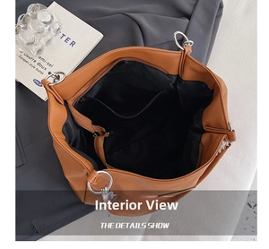 Top view of brown leather tote bag with spacious interior and black zippered pocket