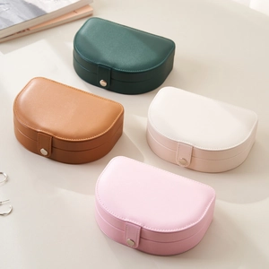 Portable semi-circle faux leather jewelry boxes in four colors with secure snap button