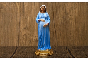 Macro detail of a 21.3cm pregnant Madonna statue in blue robes on golden base